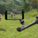 The DJI Osmo Mobile 6's telescoping arm fully extended to capture a low-angle shot.